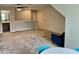 The spacious living room features a textured accent wall, neutral carpet, and access to other areas of the home at 166 Gulley Glen Dr, Garner, NC 27529