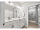 Bright bathroom featuring a double vanity with white cabinets, light countertops, and a separate glass-enclosed shower at 1727 Pinecliff Ct, Fuquay Varina, NC 27526