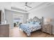 Inviting bedroom with stylish bed, fan, a private balcony, and ample natural light, creating a tranquil retreat at 1727 Pinecliff Ct, Fuquay Varina, NC 27526