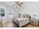 Cozy bedroom with a decorative metal frame bed, a ceiling fan, neutral decor, and natural light from the window at 1727 Pinecliff Ct, Fuquay Varina, NC 27526