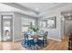 Charming dining area with a glass table, stylish chairs, a decorative rug, and a large, ornate mirror at 1727 Pinecliff Ct, Fuquay Varina, NC 27526