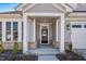 Inviting entrance with modern door, decorative wreath, and well-maintained landscaping at 1727 Pinecliff Ct, Fuquay Varina, NC 27526
