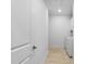 Hallway leading to laundry area with a white washer and dryer, with tile floor, providing convenience and functionality at 1727 Pinecliff Ct, Fuquay Varina, NC 27526