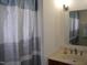 Bathroom featuring a vanity with a sink, a mirror, and a shower with a striped curtain at 1809 S Garnett Ext, Henderson, NC 27536
