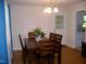 Inviting dining area with hardwood floors, a chandelier, and access to an outdoor space at 1809 S Garnett Ext, Henderson, NC 27536