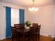 Charming dining room with hardwood floors, modern lighting fixture, and comfortable seating for six at 1809 S Garnett Ext, Henderson, NC 27536