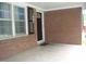Covered front porch with brick facade and large windows at 1809 S Garnett Ext, Henderson, NC 27536