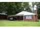 Charming brick home featuring a convenient carport, well-maintained lawn, and mature shade trees at 1809 S Garnett Ext, Henderson, NC 27536