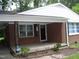Inviting brick front porch with classic columns, offering a welcoming entrance to the home at 1809 S Garnett Ext, Henderson, NC 27536