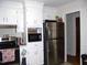 Functional kitchen featuring white cabinetry, stainless steel appliances, and good storage options at 1809 S Garnett Ext, Henderson, NC 27536