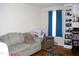 Bright living room with hardwood floors, a comfortable seating area, and built-in shelving at 1809 S Garnett Ext, Henderson, NC 27536