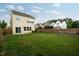 Large backyard with grass, fence, and view of the back of the home at 2001 October Dr, Durham, NC 27703