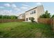 Spacious backyard featuring a well-maintained lawn and a classic wooden fence, perfect for outdoor activities at 2001 October Dr, Durham, NC 27703