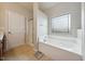 Bathroom with a soaking tub, shower, and frosted window at 2001 October Dr, Durham, NC 27703