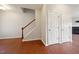 Hallway with wood floors, stairs, and two doors at 2001 October Dr, Durham, NC 27703
