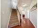 Hallway with wood floors, stairs, and views of kitchen area at 2001 October Dr, Durham, NC 27703