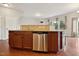 Kitchen island with granite countertops, stainless steel dishwasher, and wood flooring at 2001 October Dr, Durham, NC 27703