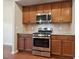 Stainless steel gas range with overhead microwave and tile backsplash at 2001 October Dr, Durham, NC 27703