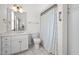 Bright bathroom with white vanity, tile flooring, and a shower with a patterned curtain at 2014 Muirfield Ct, Elon, NC 27244