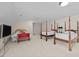Large bedroom with multiple beds, television, and comfortable seating for guests at 2014 Muirfield Ct, Elon, NC 27244