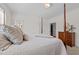 Bedroom featuring neutral tones, a wooden four-poster bed, and comfortable throw pillows at 2014 Muirfield Ct, Elon, NC 27244
