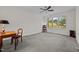 Spacious bedroom with a ceiling fan, neutral carpet and a large window with a view at 2014 Muirfield Ct, Elon, NC 27244