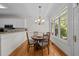 Bright breakfast nook featuring a round table, four chairs, and a large window with natural light at 2014 Muirfield Ct, Elon, NC 27244