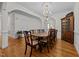 Elegant dining room with hardwood floors, a chandelier, and seating for ten at 2014 Muirfield Ct, Elon, NC 27244
