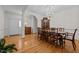 Elegant dining room featuring hardwood floors, a decorative chandelier, and archways at 2014 Muirfield Ct, Elon, NC 27244