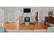 Cozy living room featuring a fireplace with a mantel, hardwood floors, and French doors at 2014 Muirfield Ct, Elon, NC 27244