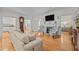Bright living room showcasing hardwood floors, a fireplace, and open access to adjacent rooms at 2014 Muirfield Ct, Elon, NC 27244