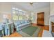 Cozy sunroom featuring a large window, a comfortable seating area, and a decorative rug at 2014 Muirfield Ct, Elon, NC 27244