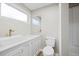 Modern bathroom with marble countertop, white cabinet and fixtures at 205 Forest Hill Ave, Rocky Mount, NC 27804