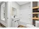 Bright bathroom showcasing a white vanity, shower-tub combo, and stylish wooden shelves at 205 Forest Hill Ave, Rocky Mount, NC 27804