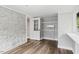 Cozy bedroom with a stone wall, hardwood floors, and a convenient built-in closet at 205 Forest Hill Ave, Rocky Mount, NC 27804