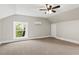 Spacious bedroom features neutral paint, carpet, window and ceiling fan at 205 Forest Hill Ave, Rocky Mount, NC 27804