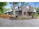 Stunning stone and siding home featuring a charming porch, mature trees, and ample parking space at 205 Forest Hill Ave, Rocky Mount, NC 27804