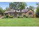 Charming stone home with a well-maintained lawn, mature trees, and inviting curb appeal at 205 Forest Hill Ave, Rocky Mount, NC 27804