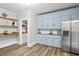 Kitchen includes stainless steel appliances, granite countertop, and light blue cabinets at 205 Forest Hill Ave, Rocky Mount, NC 27804