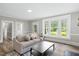 Comfortable living room showcasing hardwood floors, a large window, and a modern sofa at 205 Forest Hill Ave, Rocky Mount, NC 27804