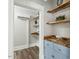 Pantry with custom wood shelving, blue cabinetry and an air conditioning unit at 205 Forest Hill Ave, Rocky Mount, NC 27804