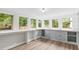 Bright sunroom featuring large windows, built-in shelving, and hardwood floors at 205 Forest Hill Ave, Rocky Mount, NC 27804
