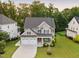 Beautiful aerial view of a landscaped home with a two-car garage and a large, green front lawn at 2083 Amalfi Pl, Apex, NC 27502