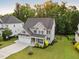 Aerial view of a beautiful home with a two-car garage and lush landscaping at 2083 Amalfi Pl, Apex, NC 27502