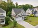 Aerial view of a beautiful home with a two-car garage and lush landscaping at 2083 Amalfi Pl, Apex, NC 27502