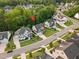 Aerial view of a residential neighborhood featuring beautiful homes and tree-lined streets at 2083 Amalfi Pl, Apex, NC 27502
