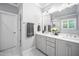 Elegant bathroom with double vanity, gray cabinets, quartz countertop, and a glass-enclosed shower at 2083 Amalfi Pl, Apex, NC 27502