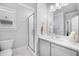 A pristine white bathroom with a glass-enclosed shower, modern fixtures, and a bright, clean aesthetic at 2083 Amalfi Pl, Apex, NC 27502