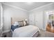 Comfortable bedroom with carpet, a bed, and a side table with lamp at 2083 Amalfi Pl, Apex, NC 27502