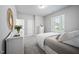 Bright bedroom with neutral tones, a large window, and elegant furnishings at 2083 Amalfi Pl, Apex, NC 27502